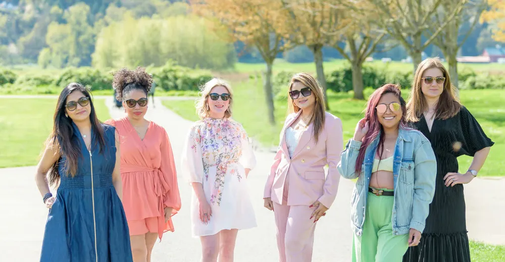 Six Seattle Wives members walking together outdoors, Sun & Sip 2025